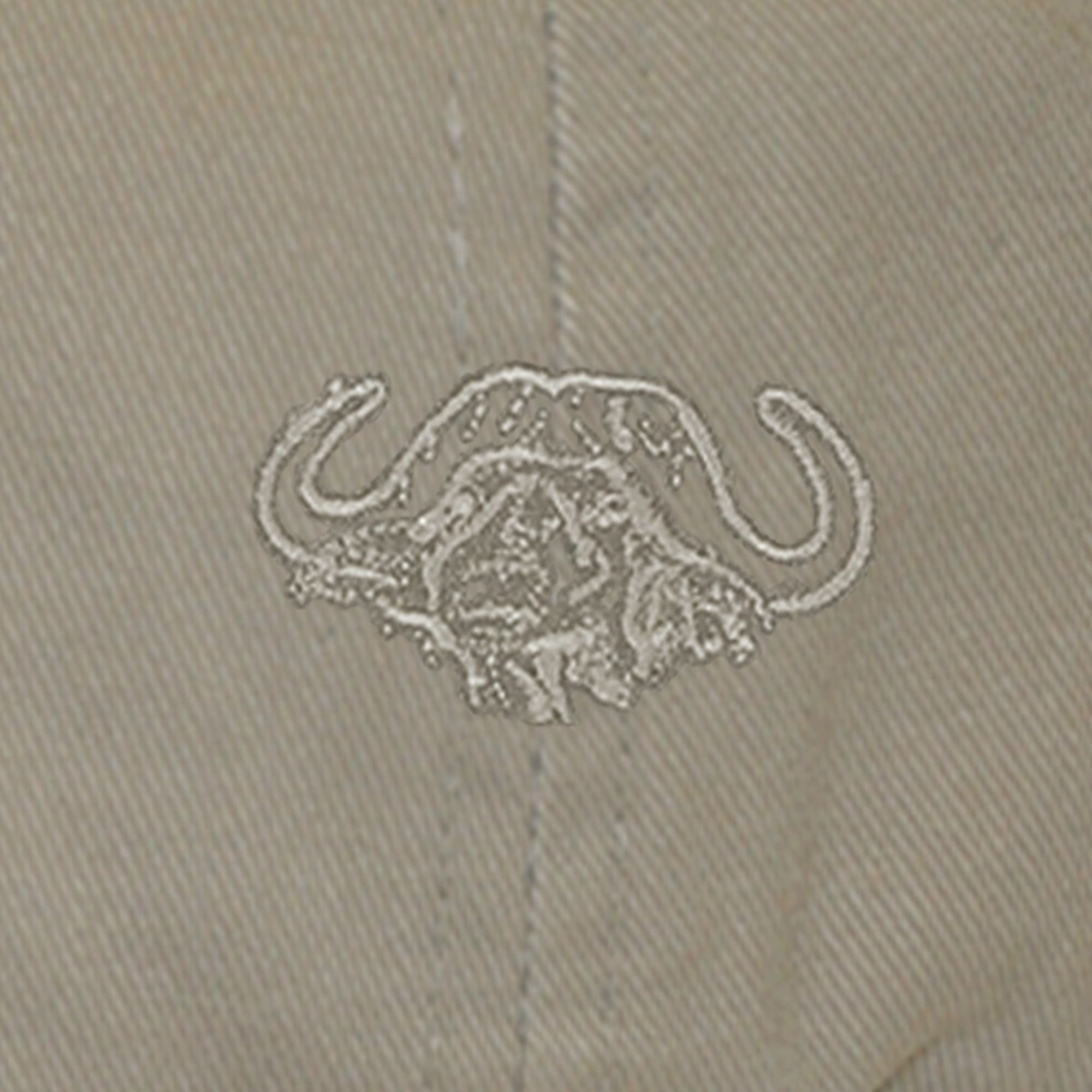 Closeup of a Buffalo Embroidered Cap, color Khaki. The cap has an embroidered Tag Safari buffalo in front. 100% cotton twill.--4