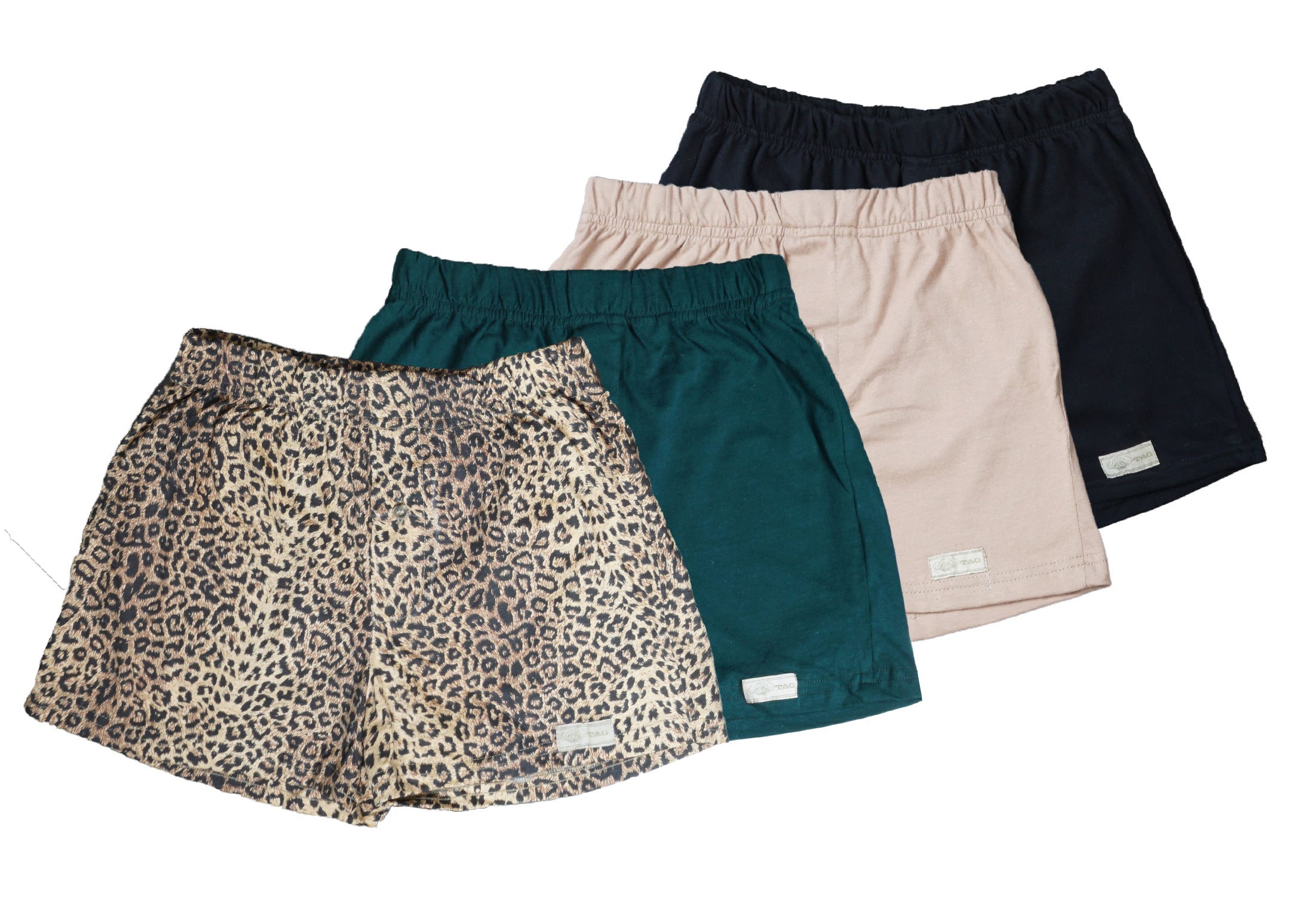 Front view of four pairs of Go Wild Boxers, one Black, one Tan, one Green, and one Leopard Print. Each have an elastic waistband, a buttoned front fly, and a Tag Buffalo label on the bottom front of the left leg. 100% cotton.--1
