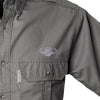 Closeup of a Men's Trail Shirt with Buffalo Logo in Short Sleeves, color Olive. The shirt has a flap-covered chest pocket on the left side with an embroidered Tag buffalo logo above, button-down collars, functional cross-stitched shoulder straps, a button-front placket, and double stitching throughout. 100% cotton.
