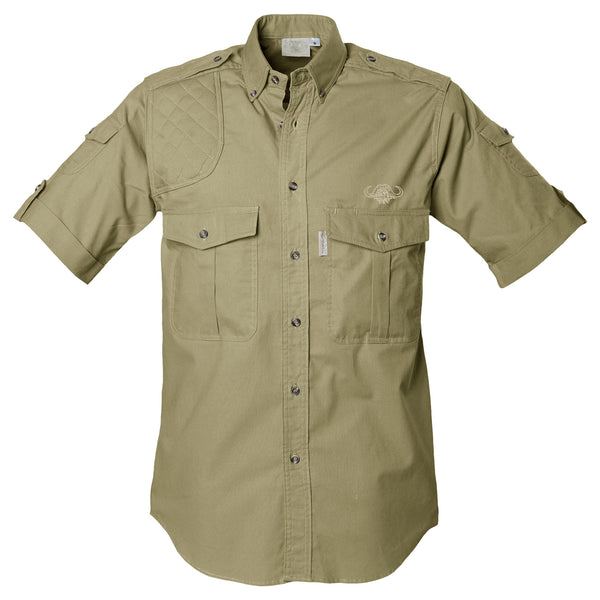 Front view of a Men's Shooter Shirt with Buffalo Logo in Short Sleeves, color Khaki. The shirt has a quilted shooting pad at the right shoulder, ammo pockets on the sleeves, two flap-covered chest pockets with an embroidered Tag buffalo logo above the left pocket, button-down collars, functional cross-stitched shoulder straps, a button-front placket, double stitching throughout, and long rounded tails for tucking into pants. 100% cotton.