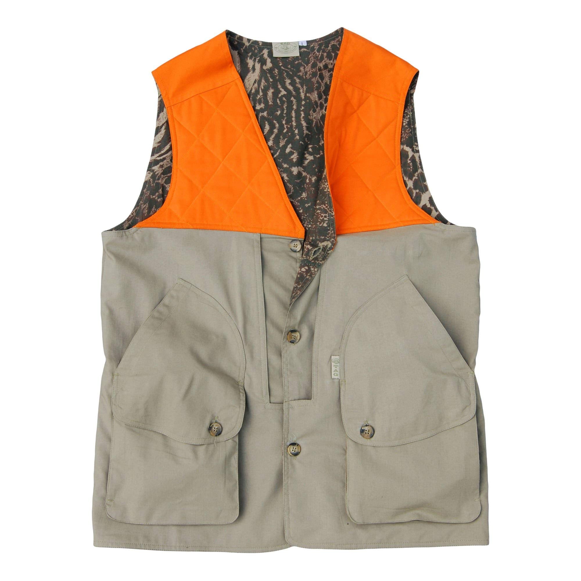Front of a Men's Safari Vest, color Khaki/Blaze Orange. The vest has a blaze orange front panel with a quilted shooter pad at each shoulder, two oversized slash pockets with flap-covered bellows pockets at the waist, two zippered security pockets inside, a buttoned front packet, a printed cotton inside liner, and double stitching throughout. 100% cotton.--1