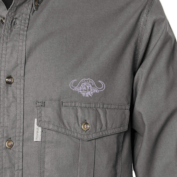 Closeup of a Men's Shooter Shirt with Buffalo Logo in Long Sleeves, color Olive. The shirt has a flap-covered chest pocket on the left side with an embroidered Tag buffalo logo above, button-down collars, a button-front placket, and double stitching throughout. 100% cotton.