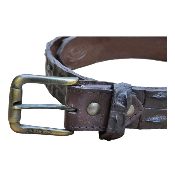 Closeup of a Nile Crocodile Game Skin Belt, color Brown. The belt has a solid brass buckle, two Chicago-style belt length adjustment screws, and a matching leather keeper loop. Genuine game skin leather.
