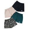 Front view of four pairs of Go Wild Boxers, one Black, one Tan, one Green, and one Olive Drab Jungle Camouflage. Each have an elastic waistband, a buttoned front fly, and a Tag Buffalo label on the bottom front of the left leg. 100% cotton.
