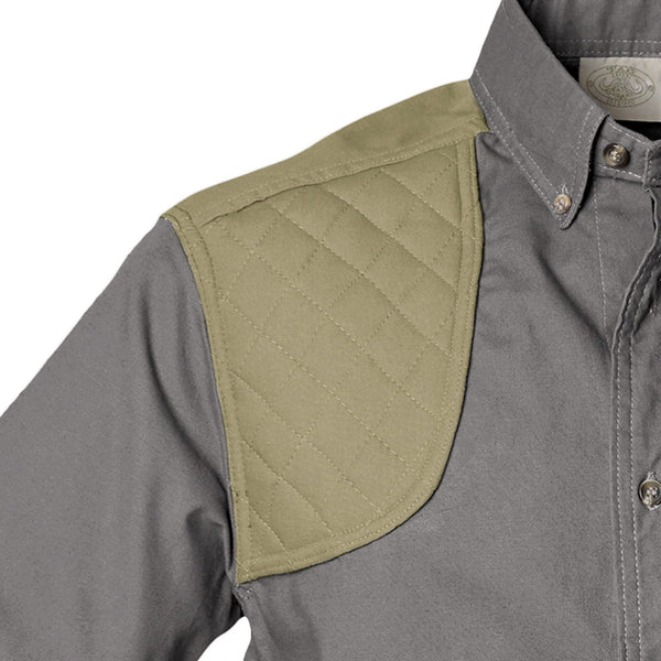 Closeup of a Men's Upland Shirt in Long Sleeves, color Olive/Khaki. The shirt has a contrasted quilted shooter patch at the right shoulder, button-down collars, a button-front placket, and double stitching throughout. 100% cotton.