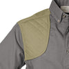 Closeup of a Men's Upland Shirt in Short Sleeves, color Olive/Khaki. The shirt has a contrasted quilted shooter patch at the right shoulder, button-down collars, a button-front placket, and double stitching throughout. 100% cotton.
