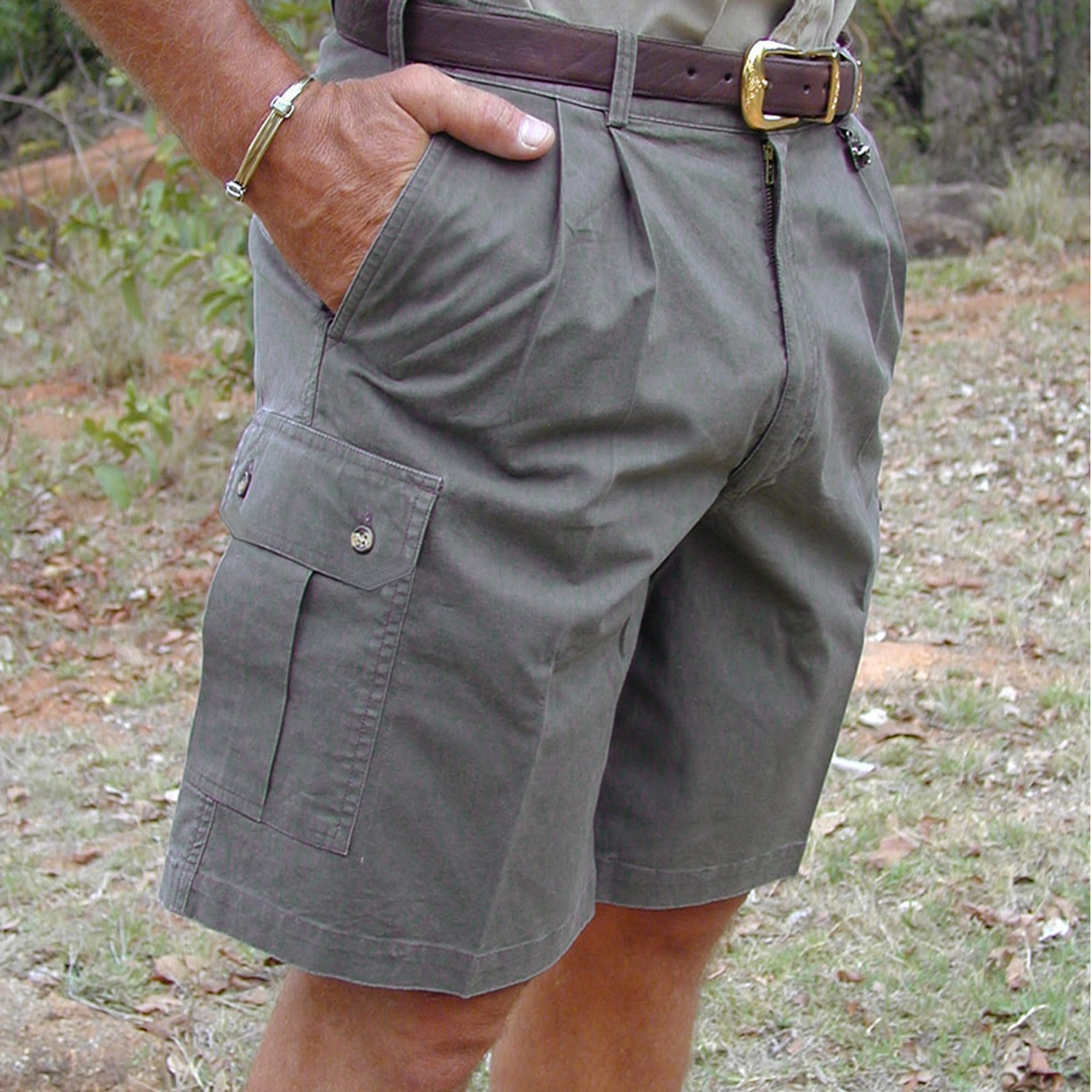 Model wearing Tag Safari Cargo Shorts for Men in Olive Gray. Shows a slash-style hip pocket, a button-flap thigh pocket, and a 9