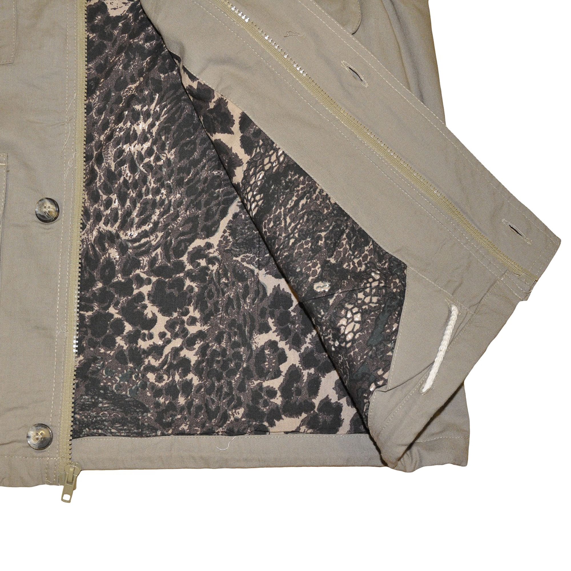 Close-up of a Tag Safari Travel Vest for Men in Khaki. Shows an Afri-Camo printed liner and a zippered and buttoned front placket.--5
