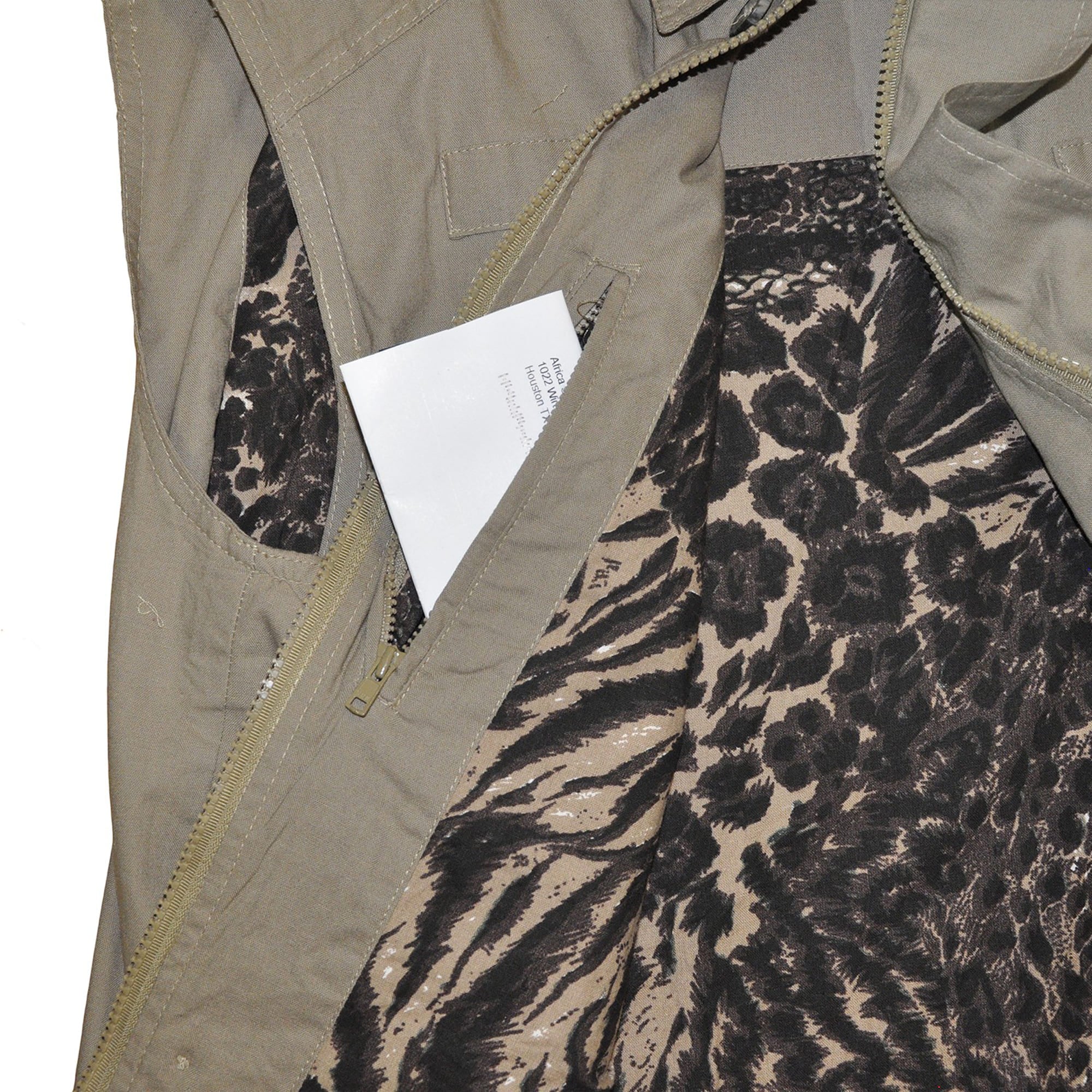 Close-up of a Tag Safari Travel Vest for Men in Khaki. Shows an Afri-Camo printed liner and a zippered inside security pocket.--4