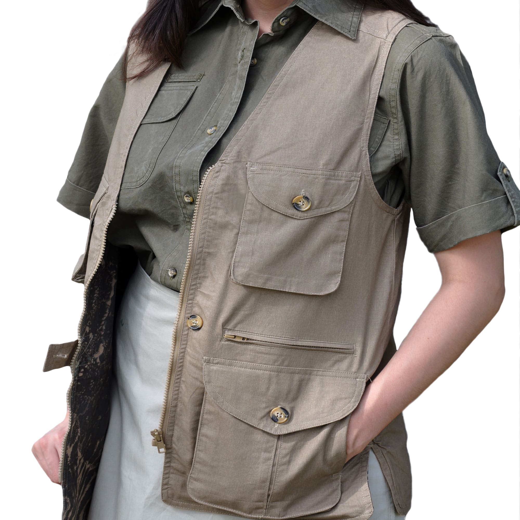 Model wearing a Tag Safari Livingstone Vest for Women in Khaki. Shows two button-flap chest pockets, two zippered waist pockets, two button-flap waist pockets, and a zippered front closure.--4
