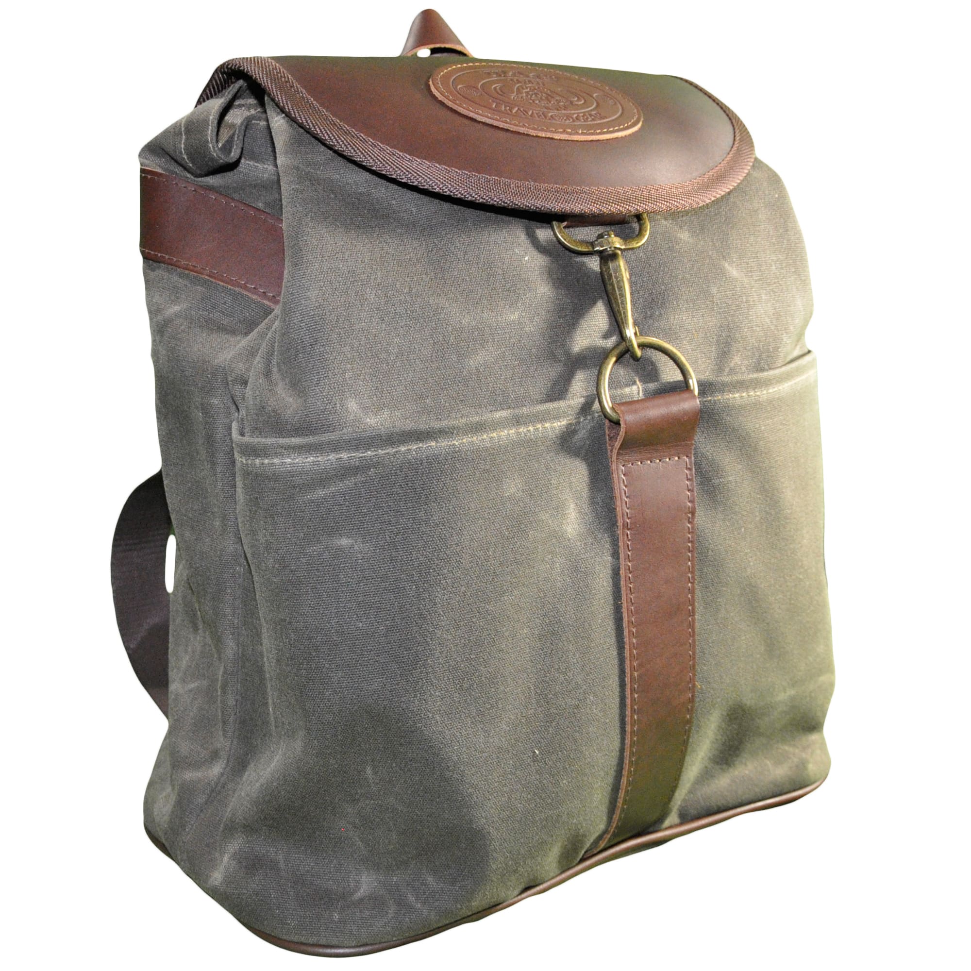 Front and left side of a Tag Safari Waxed Cotton Canvas Duffle Bag in Olive Green. Shows a leather top flap with buckle and embossed Tag logo leather patch, hand strap, and large central drop-in pockets.--2