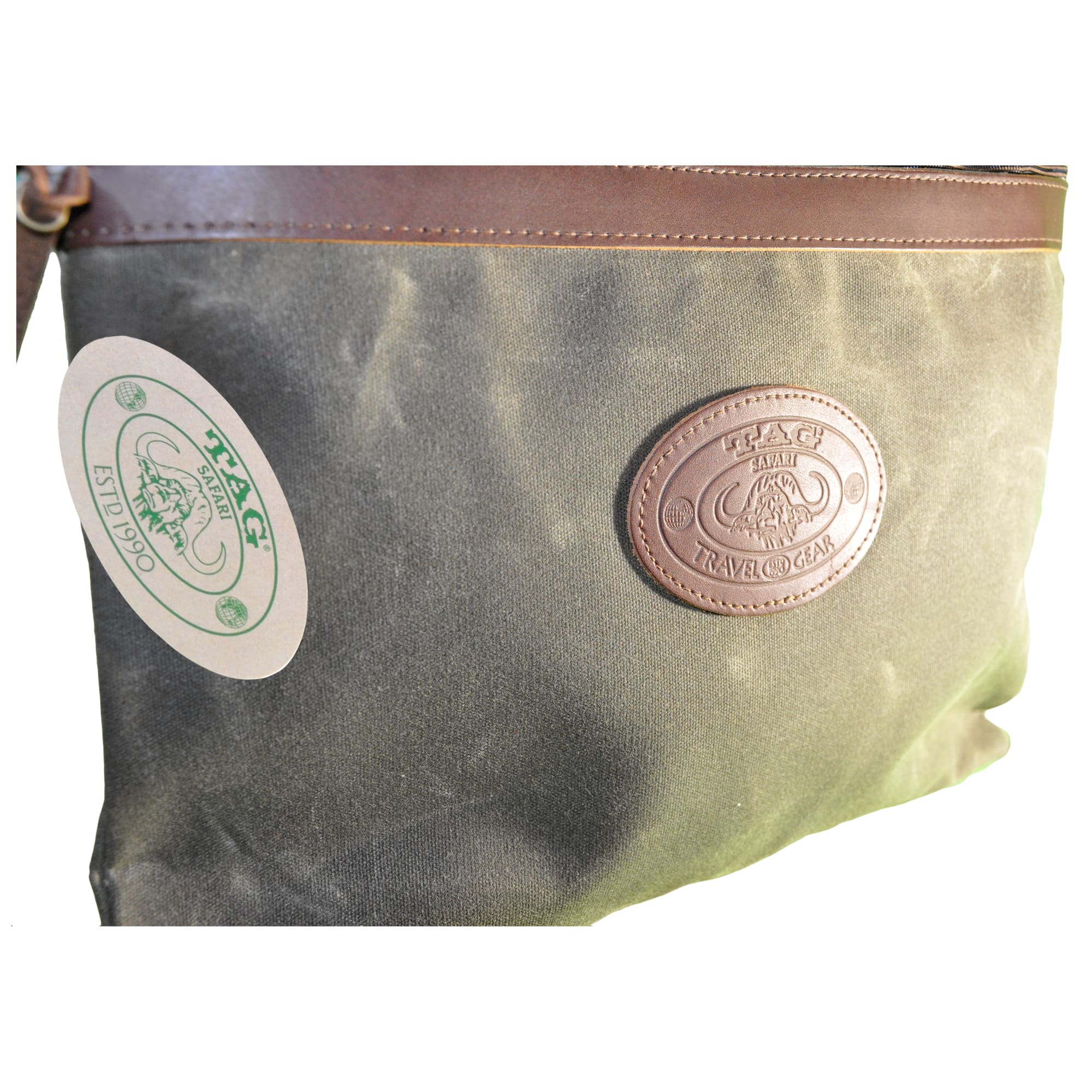 Waxed Cotton Canvas Portfolio from Tag Safari in Olive Green features a zippered top with leather trim, and an embossed Tag logo leather patch.--2