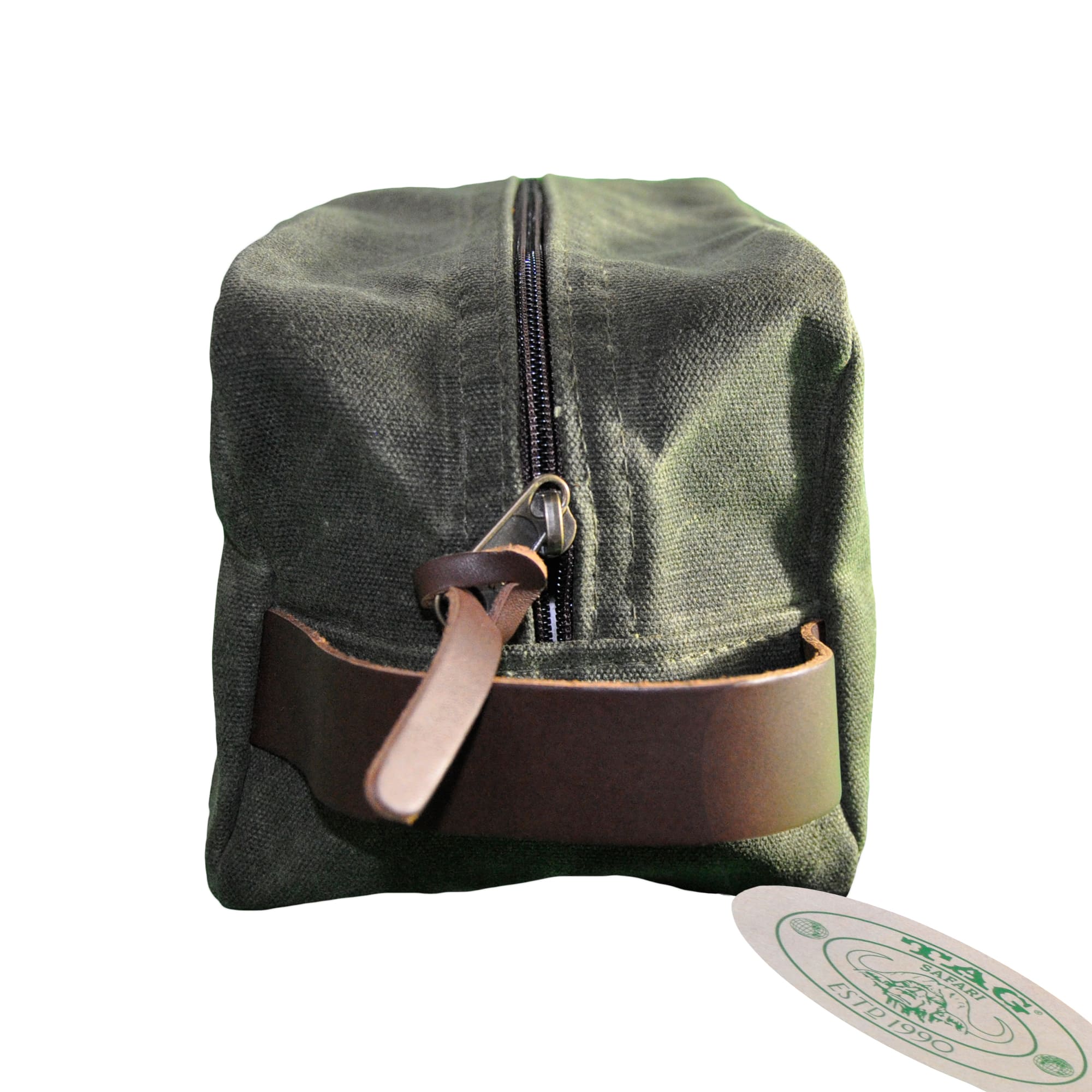 Left side of a Tag Safari Waxed Cotton Canvas Toiletry Bag in Field Tan. Shows a zippered top and leather hand strap.--7