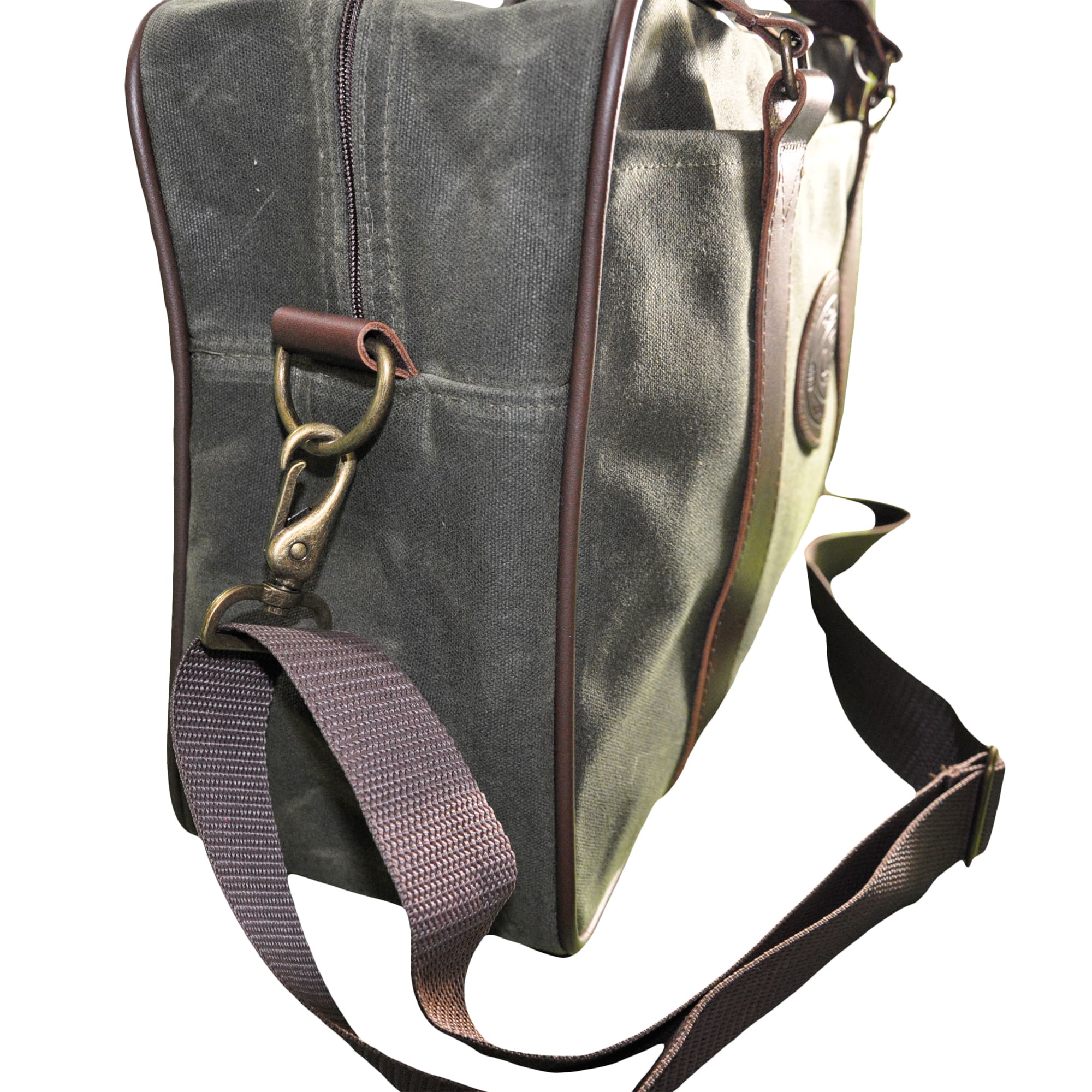Front and side of a Tag Safari Waxed Cotton Canvas Weekender Bag in Field Tan. Shows a zippered top, a large front drop-in pocket, an adjustable web-style shoulder strap, cushioned leather handles, and an embossed Tag logo leather patch.--5