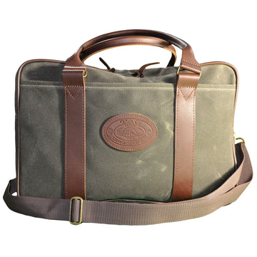 Waxed Cotton Canvas Weekender Bag from Tag Safari in Olive Green features a zippered top, a drop-in pocket in front, an adjustable web shoulder strap, cushioned leather handles, and an embossed Tag logo leather patch.