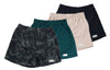 Front view of four pairs of Go Wild Boxers, one Black, one Tan, one Green, and one Gray Camouflage. Each have an elastic waistband, a buttoned front fly, and a Tag Buffalo label on the bottom front of the left leg. 100% cotton.