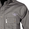 Closeup of a Men's Trail Shirt with Buffalo Logo in Long Sleeves, color Olive. The shirt has a flap-covered chest pocket on the left side with an embroidered Tag buffalo logo above, button-down collars, functional cross-stitched shoulder straps, a button-front placket, and double stitching throughout. 100% cotton.