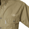 Closeup of a Men's Trail Shirt with Buffalo Logo in Short Sleeves, color Khaki. The shirt has a flap-covered chest pocket on the left side with an embroidered Tag buffalo logo above, button-down collars, functional cross-stitched shoulder straps, a button-front placket, and double stitching throughout. 100% cotton.
