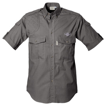 Front view of a Men's Shooter Shirt with Buffalo Logo in Short Sleeves, color Olive. The shirt has a quilted shooting pad at the right shoulder, ammo pockets on the sleeves, two flap-covered chest pockets with an embroidered Tag buffalo logo above the left pocket, button-down collars, functional cross-stitched shoulder straps, a button-front placket, double stitching throughout, and long rounded tails for tucking into pants. 100% cotton.