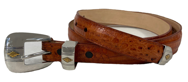 Front view of a Caiman Crocodile Game Skin Ranger Belt, color Cognac. The belt has a two-tone engraved  brass buckle, keeper loop, and end tip, five waist adjustment positioning holes, two Chicago-style belt length adjustment screws, and a Tag Safari logo branded inside. Genuine game skin leather.