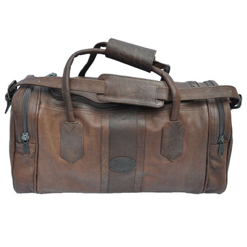 Buffalo Leather Duffle from Tag Safari in Brown features a full zippered top opening, zippered pouches on each end, an adjustable padded shoulder strap, cushioned handles, and an embossed Tag logo leather patch.