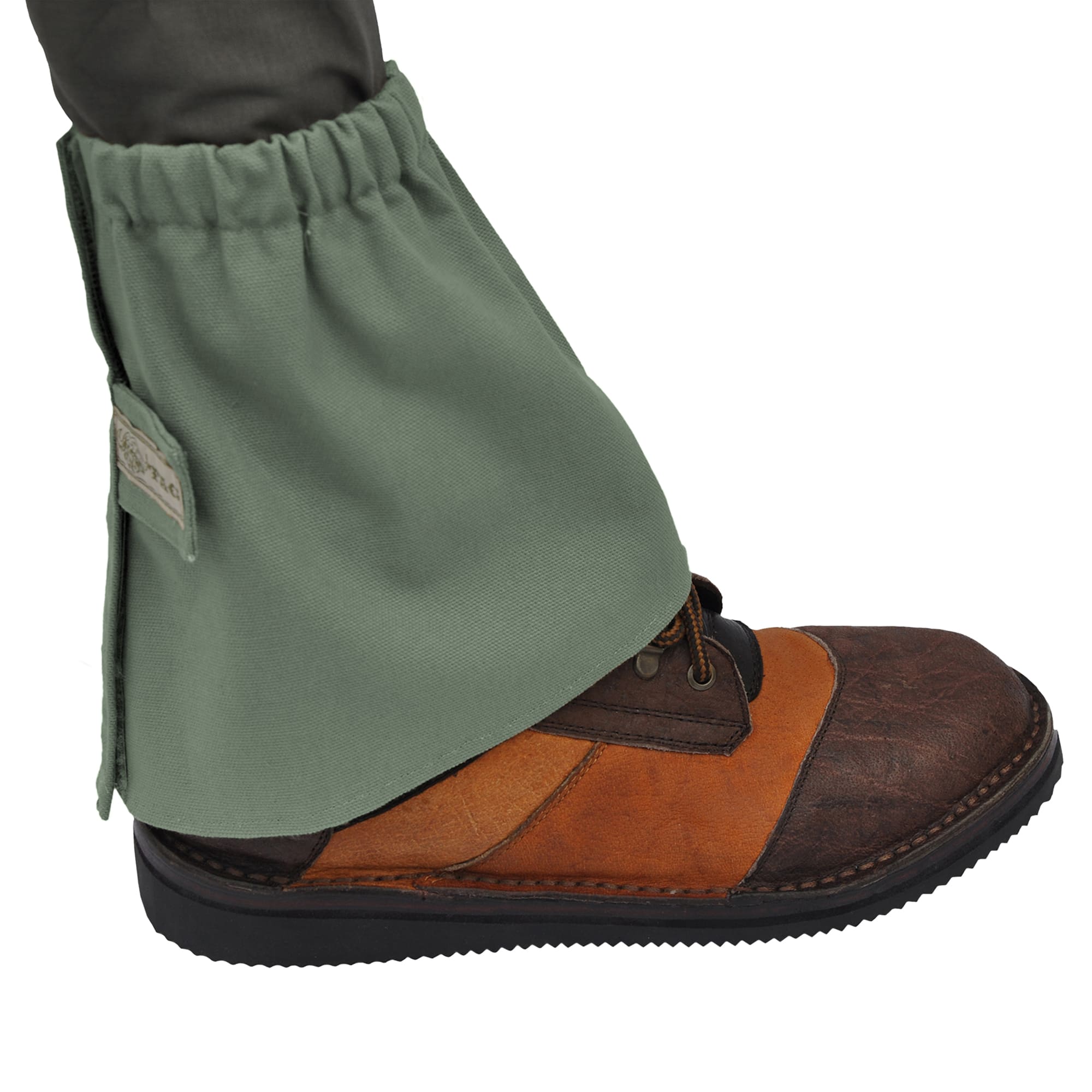 Side view of a Tag Safari Canvas Ankle Gaiter in Forest Green. Shows an elasticized top, a full-height Velcro closure, and a fabric Velcro strap with a Tag nameplate.--4