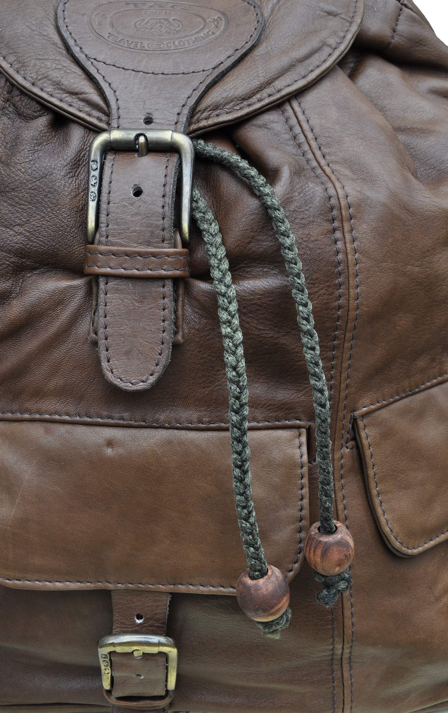 Impala Leather Backpack from Tag Safari in Brown features a buckled-flap top with embossed Tag logo, a cushioned handle, front and side flap-covered pockets, and adjustable padded shoulder straps with small flap-covered pouches.--3