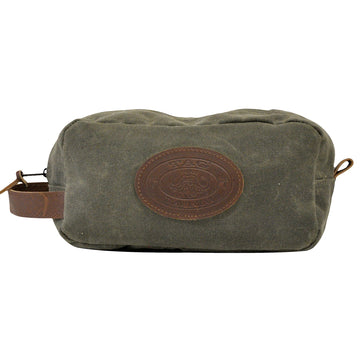 Waxed Cotton Canvas Toiletry Bag from Tag Safari in Olive Green features a zippered top, a leather hand strap on the side, and an embossed Tag logo leather patch.