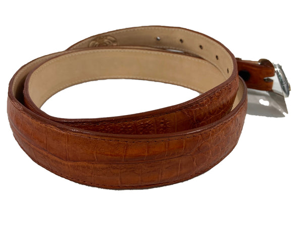Back view of a Caiman Crocodile Game Skin Ranger Belt, color Cognac. The belt has a two-tone engraved  brass buckle, keeper loop, and end tip, five waist adjustment positioning holes, two Chicago-style belt length adjustment screws, and a Tag Safari logo branded inside. Genuine game skin leather.
