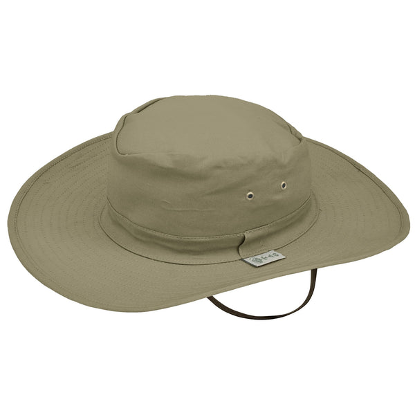 Side view of a Safari Adventure Hat, color Khaki. The hat has a tall crown with two metallic ventilation eyelets inset on each side, a matching fabric outer band with a Tag Buffalo label, a wide multi-stitched brim, a fabric sweatband, and an adjustable leather chinstrap. 100% cotton.